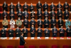 Delegates applaud as Chinese President Xi Jinping arrives for the closing session of China's National People's Congress (NPC) in Beijing, May 28, 2020.