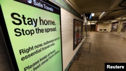 A message is seen on an electronic display inside a mostly empty 42nd Street subway station during the coronavirus outbreak in New York City, March 20, 2020. 