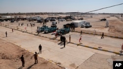 FILE - Iraqi security forces prepare to open the crossing between the Iraqi town of Qaim and Syria's Boukamal, in Qaim, Iraq, on Sept. 30, 2019. Overnight airstrikes near the crossing on Dec. 30, 2023, reportedly killed six Iran-backed militants.