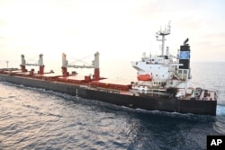 This photo provided by the Indian Navy shows U.S.-owned ship Genco Picardy that came under attack Wednesday from a bomb-carrying drone launched by Yemen's Houthi rebels in the Gulf of Aden, Jan. 18, 2024.