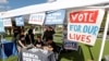 student volunteers help out at a booth to encourage on campus voting for students during a Vote for Our Lives event at the University of Central Florida in Orlando, Fla. in 2018.