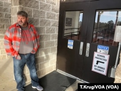 Many Arkansan schools have begun arming faculty in hopes of preventing a future school shooting. Coach Dale Cresswell stands outside a Heber Springs, Ark., school, Dec. 11, 2018 (T.Krug/VOA News)