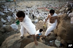 Muslim pilgrims climb Jabal Al Rahma holy mountain, or the mountain of forgiveness, at Arafat for the annual Hajj pilgrimage, outside the holy city of Mecca, Saudi Arabia, Aug. 31, 2017.