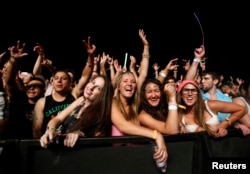 Concert-goers cheer during the performance of Canadian electrofunk duo Chromeo at the Coachella Valley Music and Arts Festival in Indio, California, April 11, 2014.