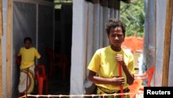 Rose Komono poses for a picture at a health clinic after overcoming the Ebola virus, in Gueckedou, Guinea, April 3, 2014.