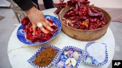 Chahida Boufaied, owner of Dar Chahida Lel Oula, prepares the Harissa in her house in Nabeul, Tunisia, Jan. 7, 2025.
