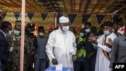 Chadian President Idriss Deby Itno (C) casts his ballot at a polling station in N'djamena, on April 11, 2021.