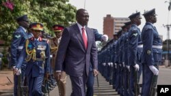 FILE - Kenyan President William Ruto, center, reviews the honor guard in Nairobi, Kenya, on Nov. 21, 2024. Ruto announced on Nov. 30, 2024, that he and the president of Uganda will help mediate a dispute between Somalia and Ethiopia.