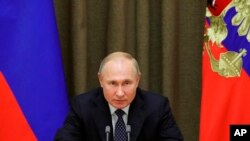 FILE - Russian President Vladimir Putin meets with officials in Moscow, Russia, Dec. 3, 2019. This week he signed a law increasing fines and penalties against so-called "foreign agents" working in mass media.