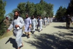 FILE - Prisoners are released from Bagram Prison in Parwan province, Afghanistan, May 26, 2020.