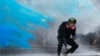 An anti-government protester is sprayed with blue-colored water by the police during a demonstration near Central Government Complex in Hong Kong, China, Sept. 15, 2019. 