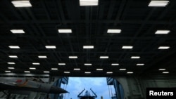 FILE - Fighter jets are seen on China's aircraft carrier Liaoning during a military drill of the Chinese People's Liberation Army (PLA) Navy in the East China Sea, April 20, 2018.