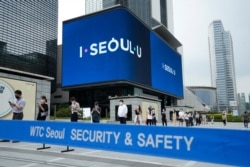 People queue in line to wait for coronavirus testing at a testing site in Seoul, South Korea, July 8, 2021.
