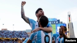 Argentina midfielder Lionel Messi (10) congratulates Argentina forward Gonzalo Higuain (9) after he assisted on Higuain's goal against the Venezuela during the first half of quarter-final play in the 2016 Copa America.