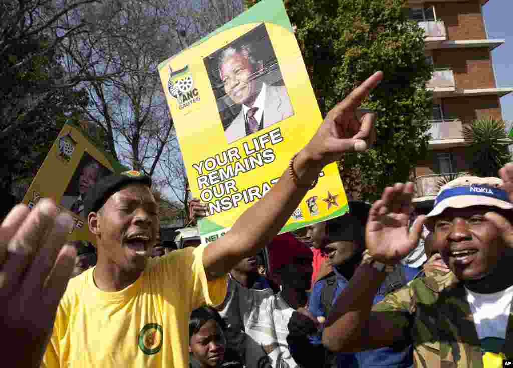 Members of the ruling party youth league sing outside the Mediclinic Heart Hospital where Nelson Mandela is being treated, July 17, 2013.