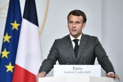 FILE - French President Emmanuel Macron speaks during a press conference at the Elysee Presidential Palace, in Paris, July 9, 2021.