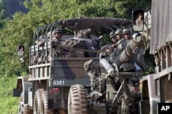South Korean army soldiers ride on the back of a truck during an annual exercise in Paju, near the border with North Korea, South Korea, July 4, 2017.