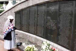 FILE - A woman prays for the victims at the memorial site in Nairobi, Kenya, Aug. 7, 2013, during events marking the 15th anniversary of the bombing of the U.S. Embassy in the city.