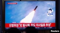 People watch a TV broadcasting file footage for a news report on North Korea firing an unidentified projectile, in Seoul, South Korea, Nov. 28, 2019.