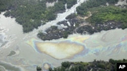 In this March 24, 2011 file photo, oil is seen on the creek's surface near an illegal oil refinery in Ogoniland, outside Port Harcourt, in Nigeria's Delta region (AP).