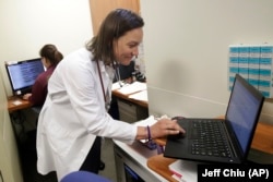 In this April 9, 2019 photo, Dr. Megan Mahoney types into a computer at the Stanford Family Medicine office in Stanford, California. “We want to do as much outside the walls of the clinic as we can,” says Mahoney, noting that this push to keep patients he