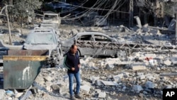 A resident checks the site of an Israeli airstrike in Tyre, southern Lebanon, Nov. 9, 2024. 