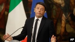 Italian Prime Minister Matteo Renzi speaks during a press conference at the premier's office Chigi Palace in Rome, early Monday, Dec. 5, 2016. Renzi acknowledged defeat in a constitutional referendum and announced he would resign on Monday. 