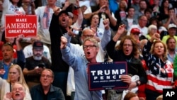 Supporters of Republican presidential candidate Donald Trump yell at reporters as they arrive for a campaign rally, in Cincinnati, Ohio, Oct. 13, 2016.