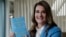 FILE - Melinda Gates displays her new book, "The Moment of Lift," in Kirkland, Wash., April 18, 2019. 
