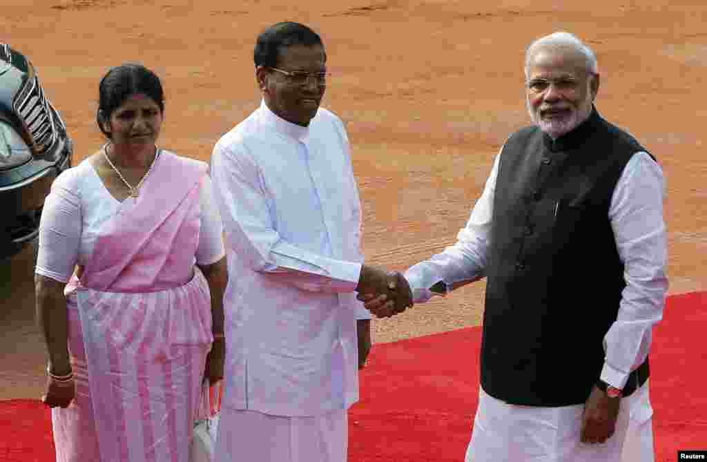 Sri Lanka's President Mithripala Sirisena (center) shakes hands with Indian Prime Minister Narendra Modi as his wife Jayanthi Sirisena looks on during the reception of Sirisena at the Rashtrapati Bhavan Presidential Palace in New Dehli, Feb. 16, 2015.