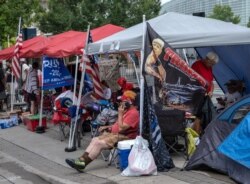 Supporters of U.S. President Donald Trump camp near the BOK Center in Tulsa, Oklahoma, June 19, 2020.