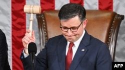 US Speaker of the House Mike Johnson, Republican from Louisiana, holds up the gavel after he won the vote for Speaker of the House, during the first day of the 119th Congress in the House Chamber at the US Capitol in Washington, DC, on January 3, 2025. (