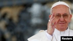 Pope Francis waves as he leads the weekly audience in Saint Peter's Square at the Vatican, April 10, 2013. 