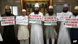 Indian Muslims hold placards during a condolence meeting and protest against Fridays mass shootings in New Zealand in Mumbai, India, March. 15, 2019.