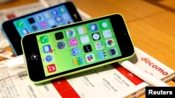 FILE - These then-new Apple iPhone 5c models were on display in at Tokyo store, Sept. 20, 2013. A 5c was at the center of Apple's battle with the FBI over efforts to break the company's proprietary auto-destruct security system. 