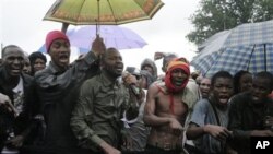 People originally from Mali's north protest in the rain against the Islamist takeover of northern Mali, in the capital, Bamako, Mali, July 4, 2012.