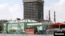 Men carry injured people outside the building of Ministry of Communication and Information Technology in Kabul, Afghanistan, April 20, 2019.