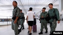 Riot police patrol inside Hong Kong International Airport in Hong Kong, Sept. 22, 2019. 