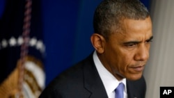 President Barack Obama listens to a question from a reporter at the White House in Washington, May 21, 2014, after he met with Veterans Affairs Secretary Eric Shinseki and Deputy Chief of Staff Rob Nabors.