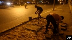 Morsi supporters remove part of a street to block a highway that links to the airport, Cairo, July 12, 2013.