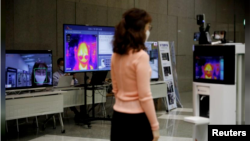 A self-driving robot checks the body temperature of an employee during a demonstration at the headquarters of SK Telecom in Seoul, South Korea, on May 26, 2020. (REUTERS/Kim Hong-Ji)