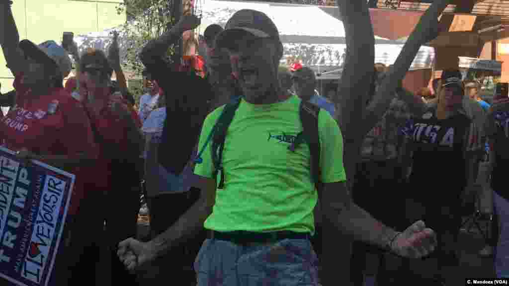 A pro Trump protester screams "Why can't we all get along," as the crowd chanted on both sides at the protest in Phoenix, Aug. 22, 2017.