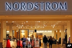 In this Wednesday, Feb. 8, 2017, photo, shoppers walk into a Nordstrom store in Pittsburgh.