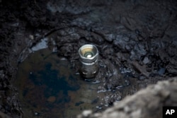 This July 11, 2017 photo shows an illegal tap into a state-owned pipeline created by fuel thieves in the middle of a cornfield in San Bartolome Hueyapan, Tepeaca, Mexico.