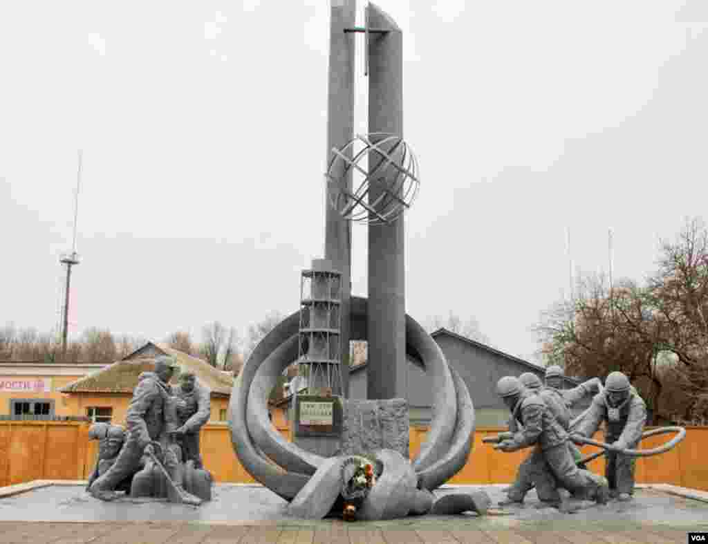 A monument in front of a fire station to the 32 firefighters who died responding to the explosion at Reactor No. 4, Chernobyl, Ukraine, March 19, 2014. (Steve Herman/VOA)