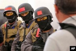 FILE - Members of a Tunisian police commando unit listen to instructions during a drill at the Jordan Gendarmerie Training Academy, in al-Swaqa, about 44 miles (70 kilometers) south of Amman, Jordan, March 18, 2018. The U.S.-funded center conducts counterterrorism training for law enforcement agencies from a pool of 56 eligible partner countries.