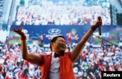 FILE - South Korean rapper Psy performs during a public screening before the 2014 World Cup Group H soccer match between South Korea and Russia, in Seoul June 18, 2014.