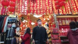 People wear face masks to protect against the spread of the coronavirus as they shop at a decoration store for the upcoming Chinese New Year celebrations in Taipei, Taiwan, Sunday, Jan. 30, 2022. (AP Photo/Chiang Ying-ying)