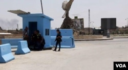Kurdish forces man a checkpoint in Hasaka City, Syria, Nov. 27, 2015.