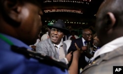 Peter Godsday Orubebea (C), Peoples Democratic Party agent, disrupts the announcing of election results in Abuja, Nigeria, March 31, 2015.